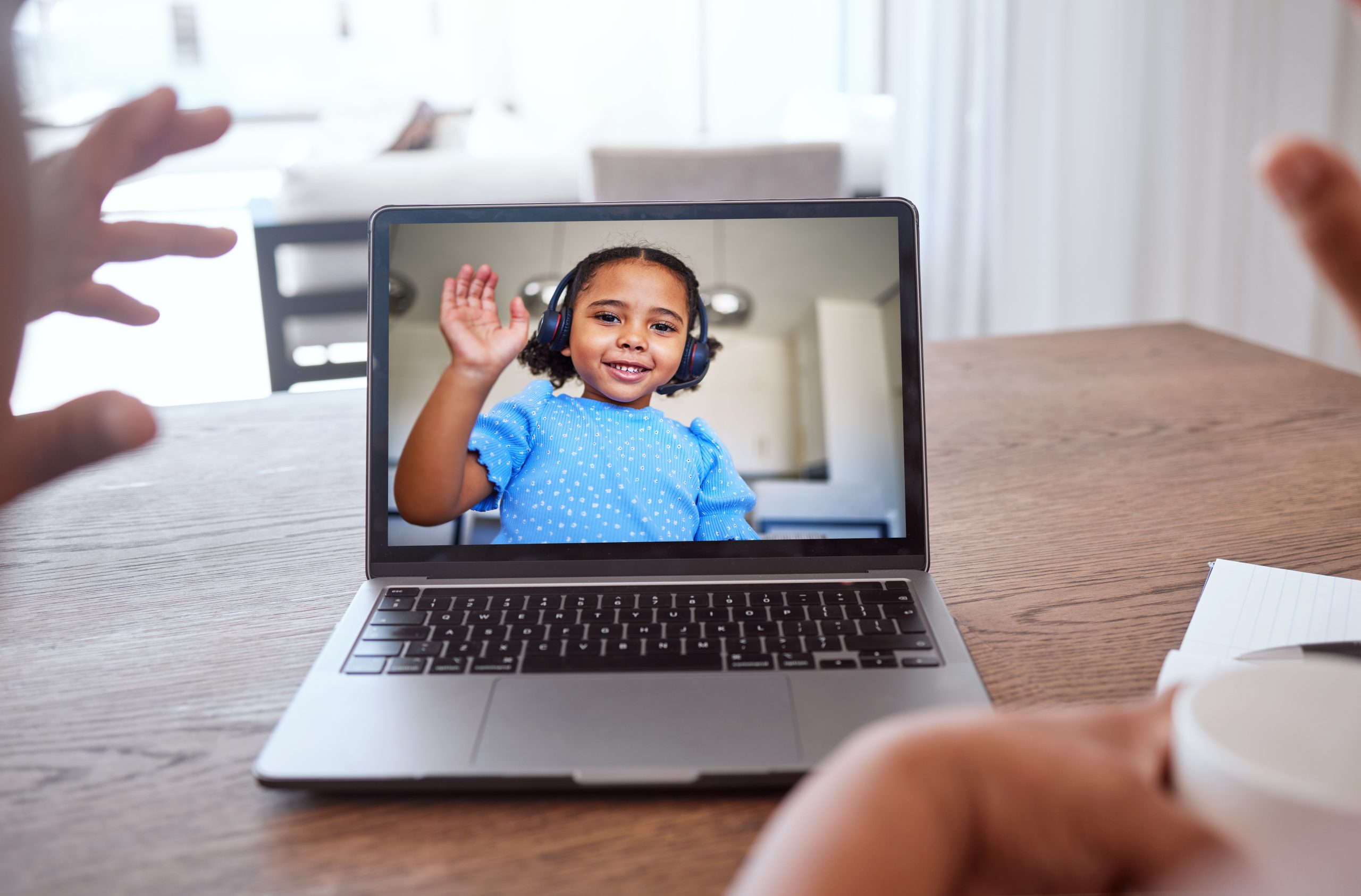 Laptop, video call and child wave at family, teacher and to connect online with headphones. Digital.